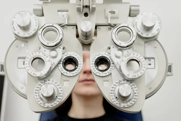Patient looking through a phoropter during a sight test